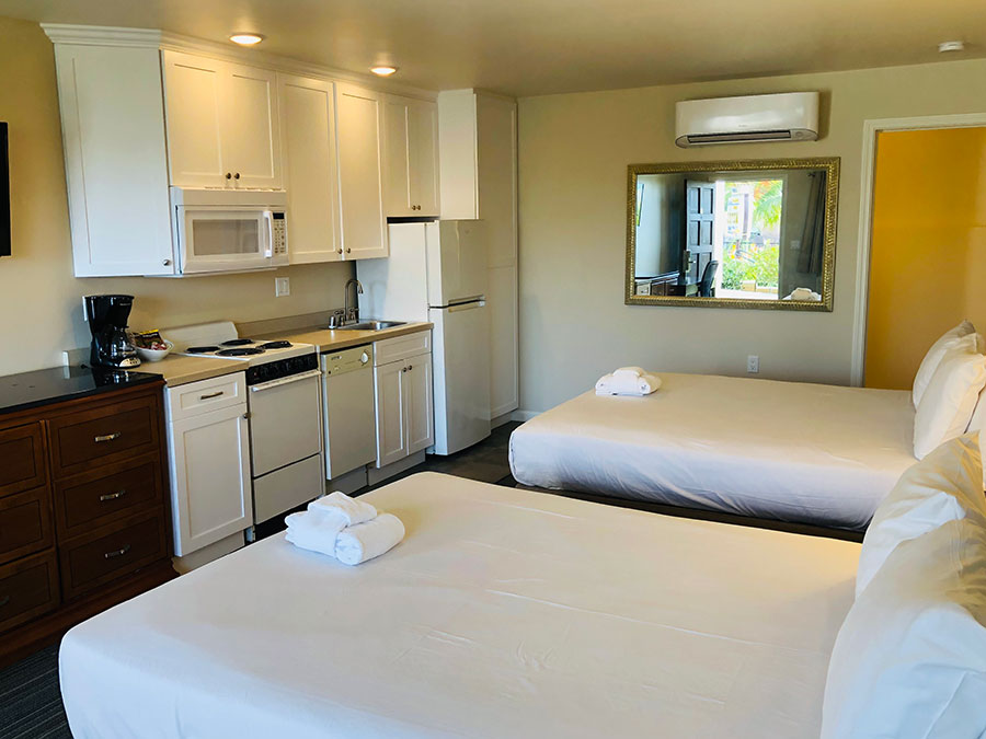 guest room with two queen beds and kitchenette